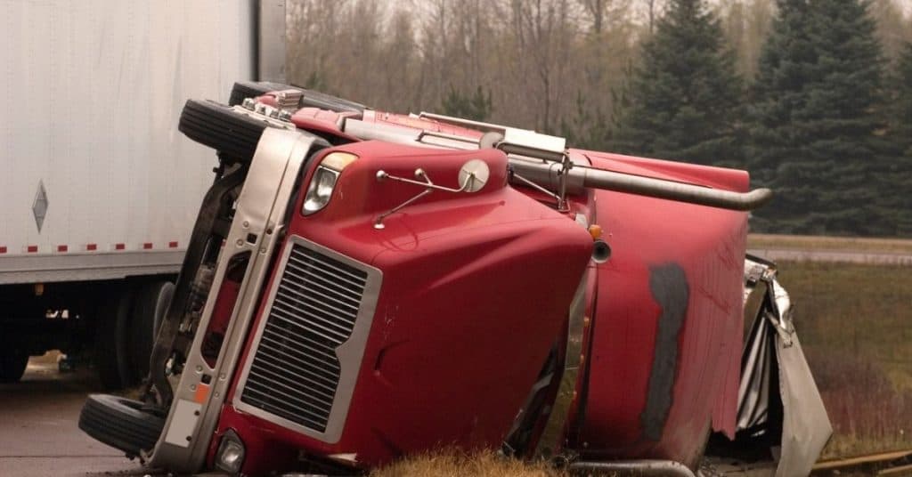 red truck flipped over on its' side