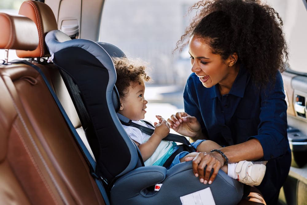 child and mother Mother comforting child in the child seat