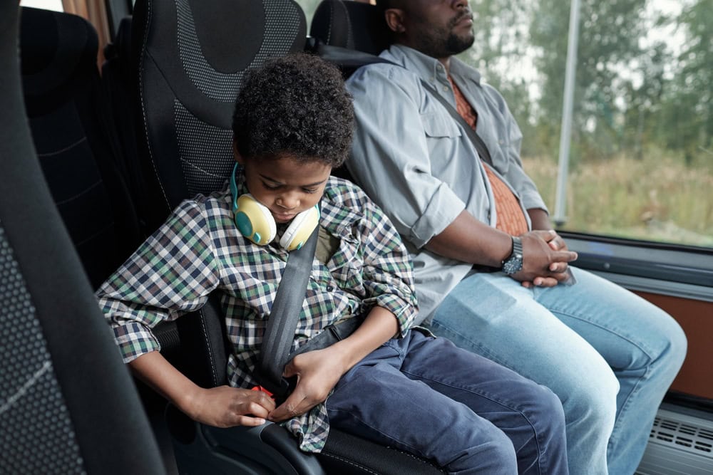 Child Fixing Seat Belt Photo of a Child Fixing Seat Belt