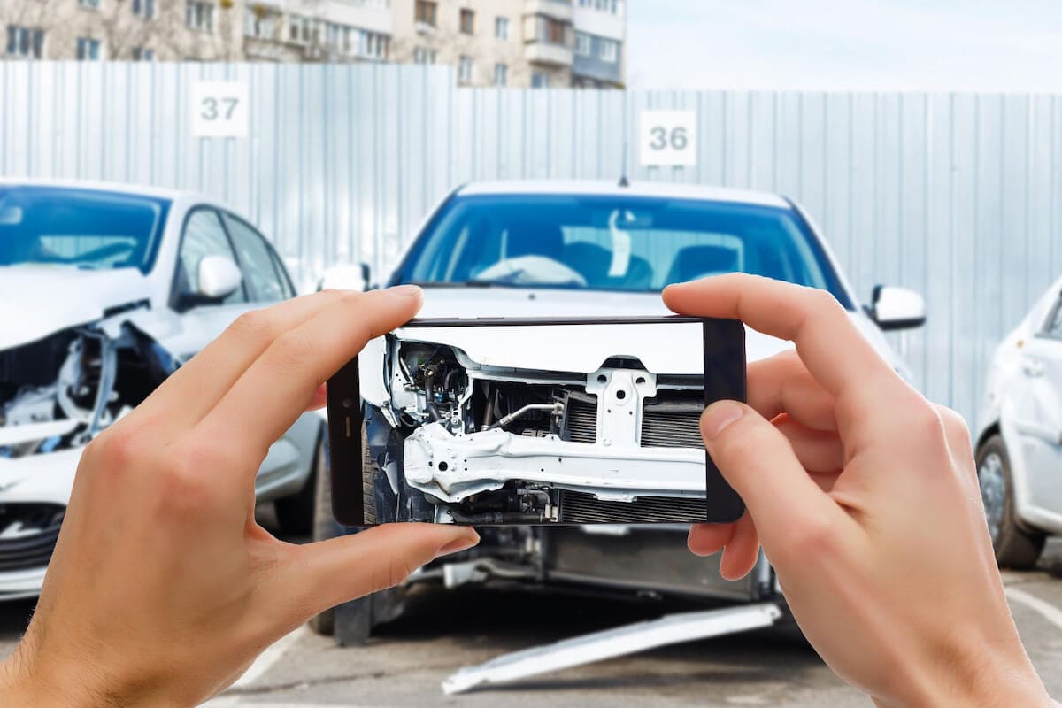 Aftermath of Head-On Collision Person Taking Picture of Car After Head-On Collision